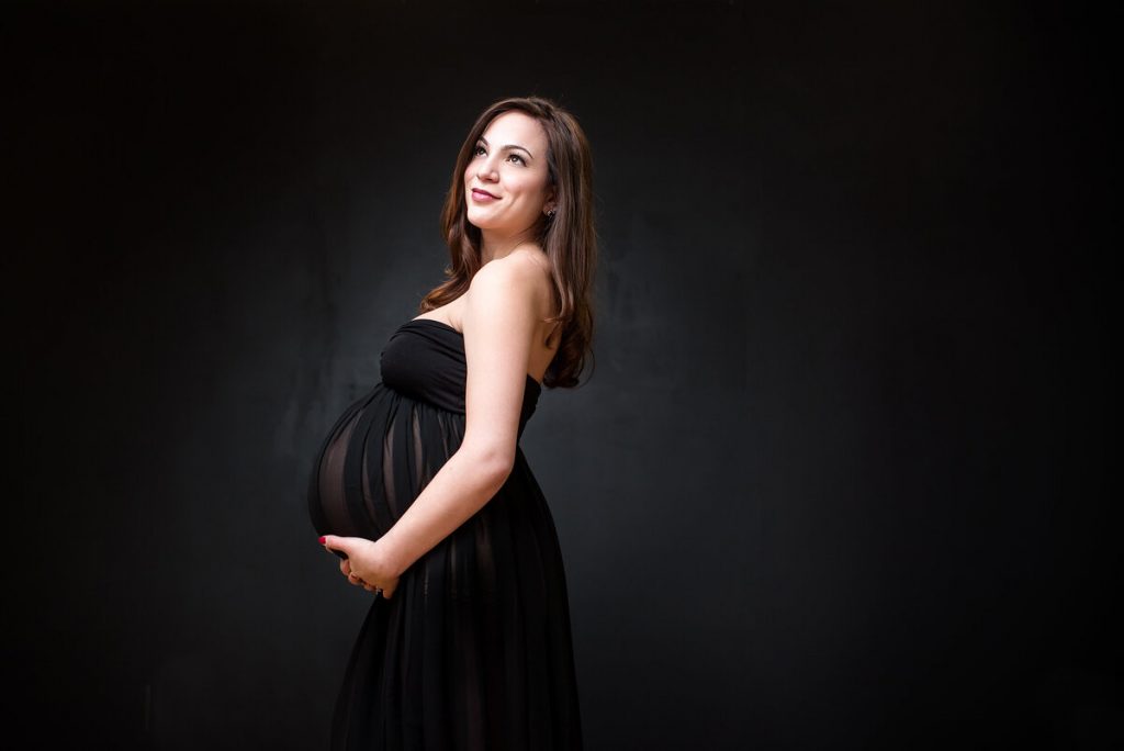 maternity photo of woman in black dress